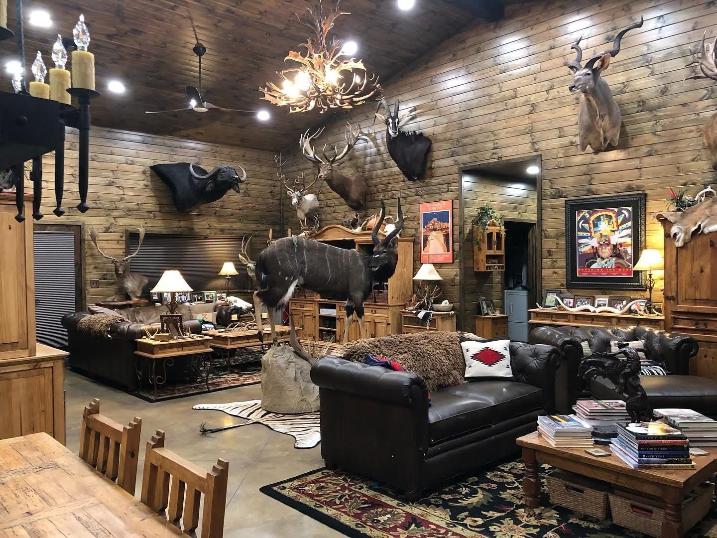 Great room with wood plank walls, vaulted ceiling and antler chandelier